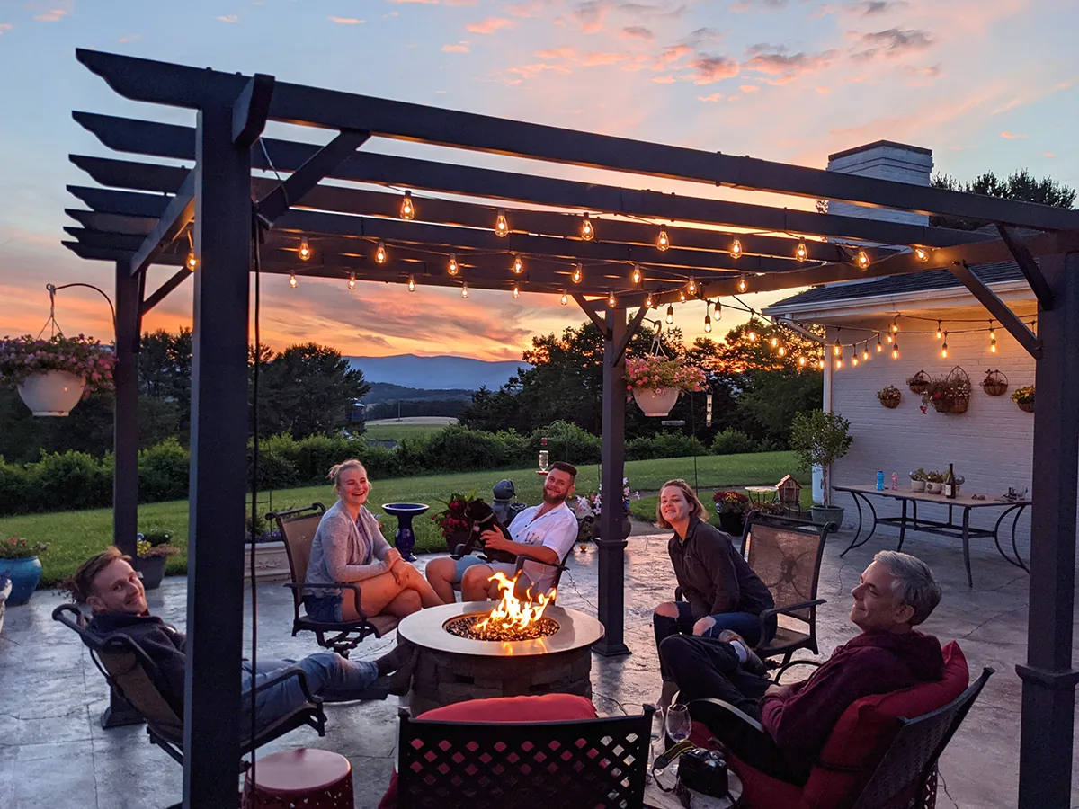 A family relaxing around a fire pit